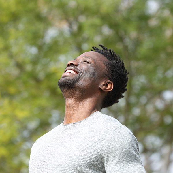 African American male smiling to the sky