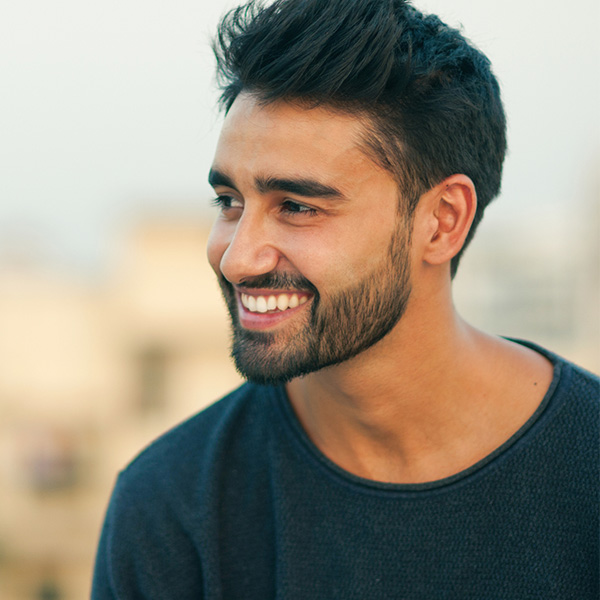 Side view portrait of a beautiful smiling man